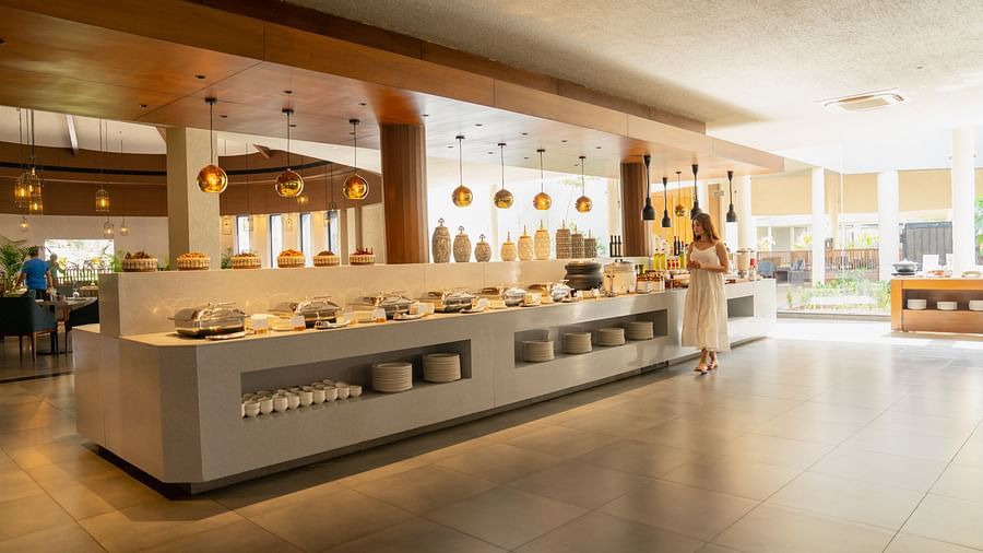 Woman walking through the buffet section of Annata Spa and Resort, Ajabgarh