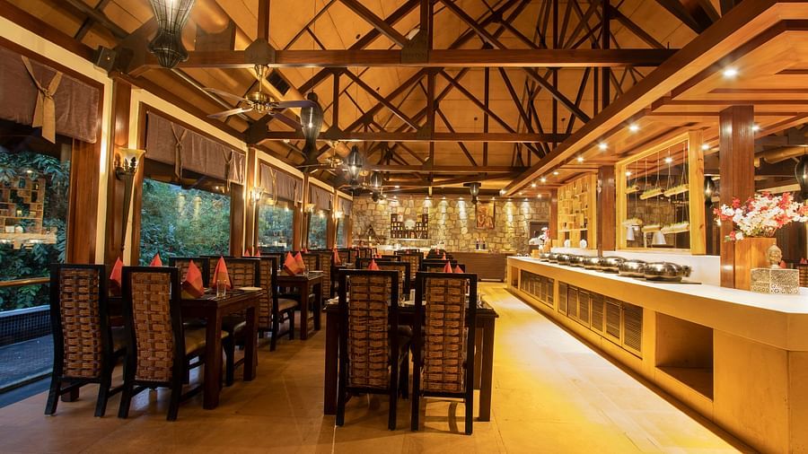 The interiors of Oasis, our multi-cuisine restaurant in Pushkar with tables and chairs and a buffet table 