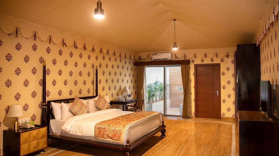 The interiors of our tent suites in Pushkar with a bed, a sofa set and tasteful decor 