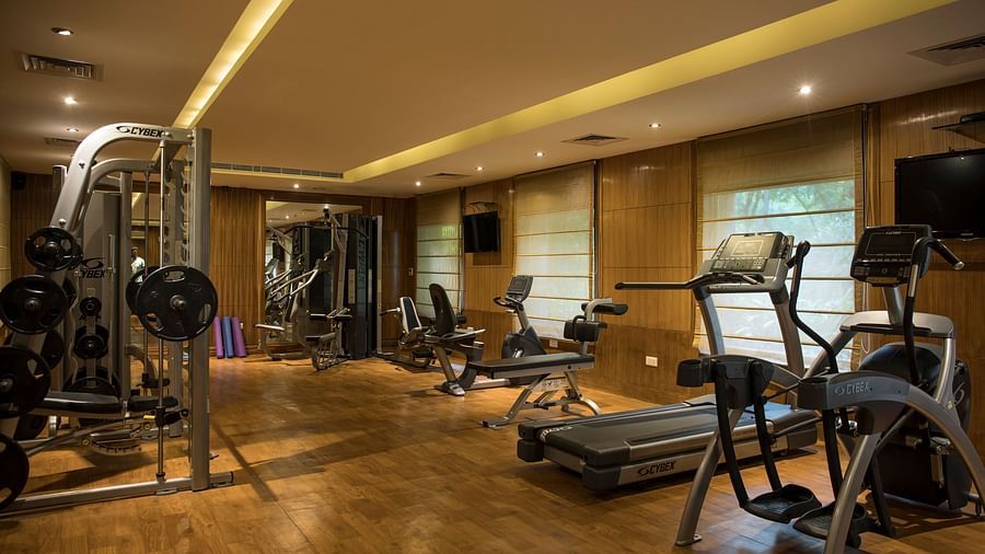 Fully equipped gym at Ananta Spa & resort, Pushkar featuring equipment including ellipticals, tradmills, cycling and weight lifts 