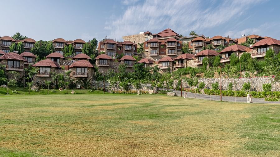 A wide view of the resort with the garden in the foreground - Ananta udaipur