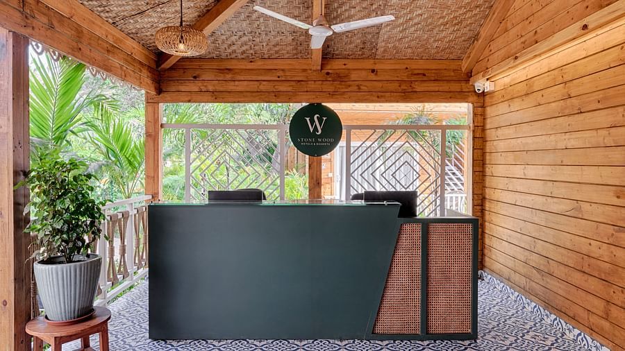 front desk reception with beams supporting the roof and a patterned tile floor