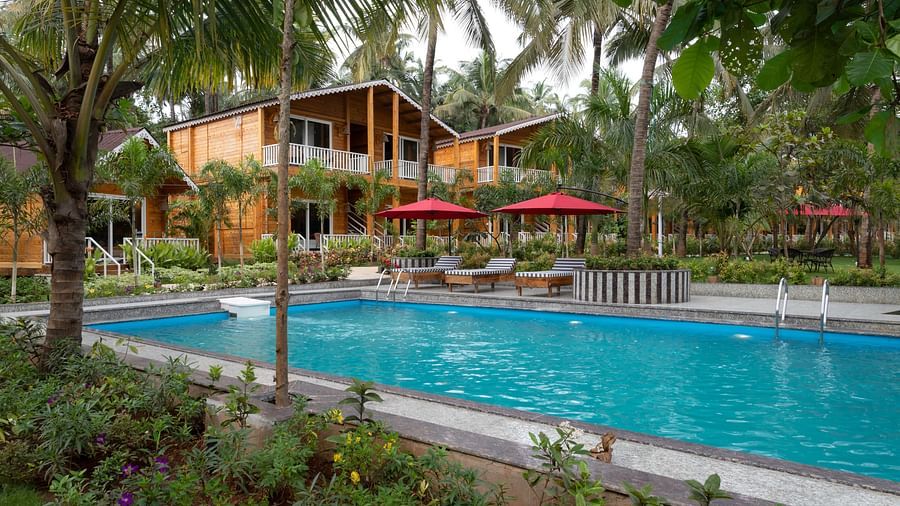 A view of the swimming pool area, showcasing the detailed landscaping and inviting poolside environment Aralea Beach Resort by Stone Wood, Morjim