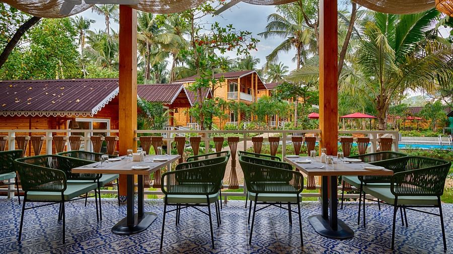 Another angle of the dining area with a focus on the patterned tile floor and the view of the tropical resort setting Aralea Beach Resort by Stone Wood, Morjim