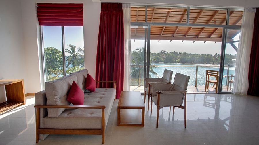 image of the common seating area at the sea view superior suite with a three seater beige couch at the sea view superior suite at the beacon by the bay villas and suites