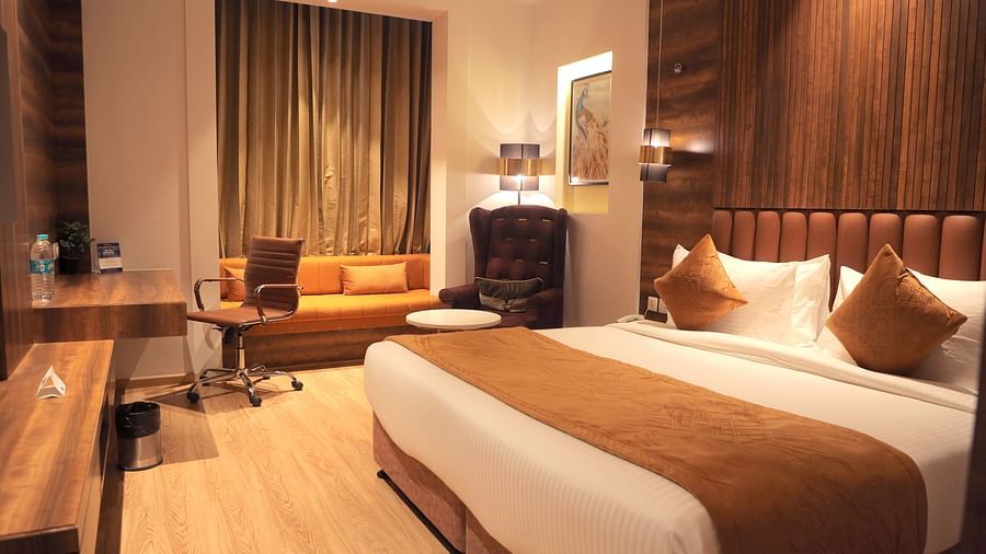 room with a king size bed and wooden flooring at best western vrindavan