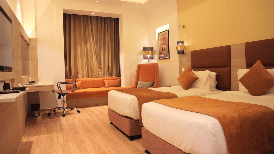 room with twin beds and wooden flooring at best western vrindavan