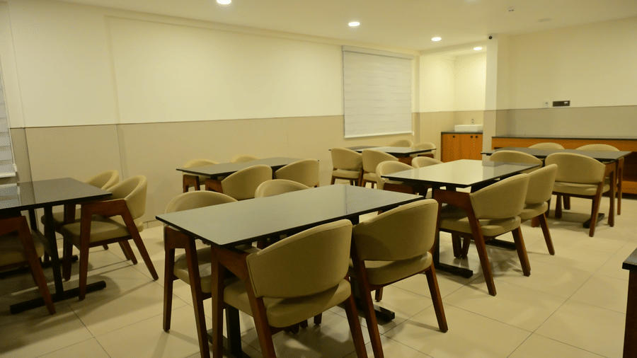 Banquet hall of Bhavanis Vista By Icon featuring tables and chairs arranged in rows.