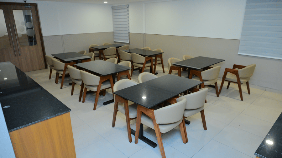 Banquet hall of Bhavanis Vista By Icon featuring tables and chairs arranged for seating.