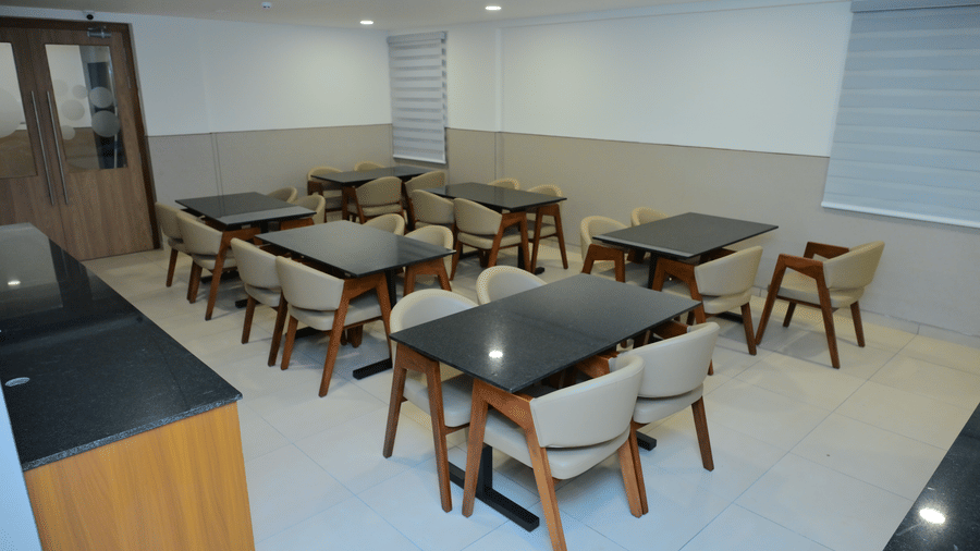 Banquet hall of Bhavanis Vista By Icon featuring tables and chairs arranged for seating.