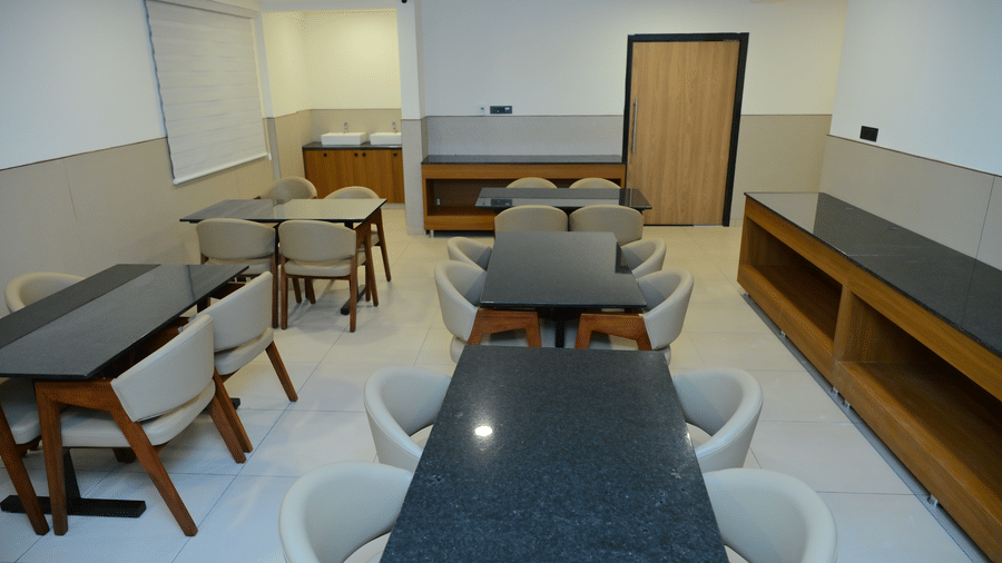 Banquet hall of Bhavanis Vista By Icon featuring tables and chairs arranged for seating.