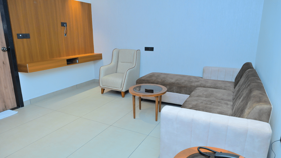 Bedroom of Bhavanis Vista By Icon featuring a bed, a headboard, and a bedside table.