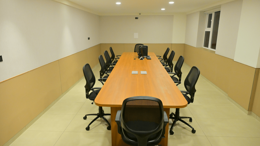 Conference room of Bhavanis Vista By Icon featuring a table and chairs.