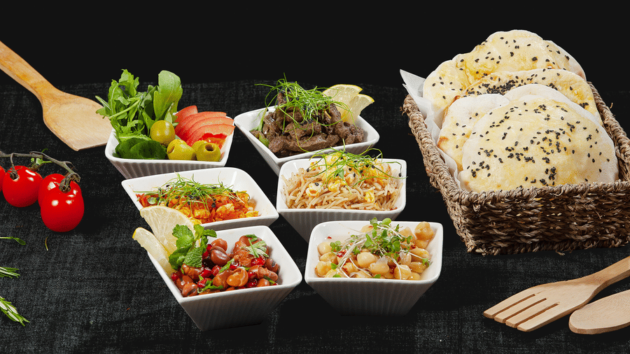 Meal prep containers featuring cooked food and fresh vegetables.