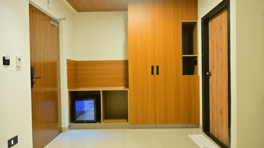 Room entrance of Bhavanis Vista By Icon featuring a wardrobe, a television, and a door.