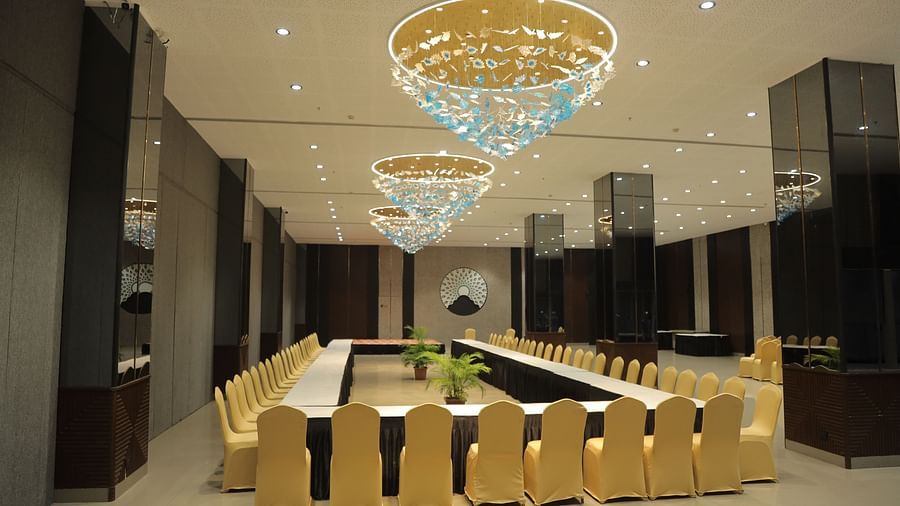 A formal conference room arranged with a U-shaped table and chairs, ready for business meetings - Biznotel By Pride Surat