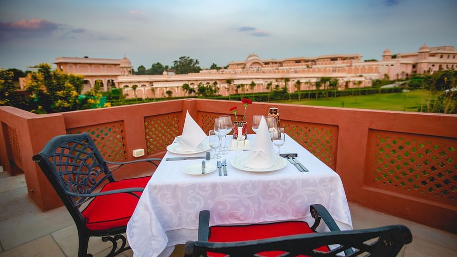 Buena Vista Luxury Garden Spa Resort - outdoor dining seating space overlooking the garden area of the Jaipur resort