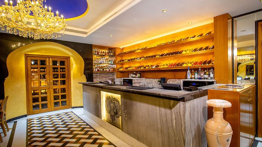 Buena Vista Luxury Garden Spa Resort - the cash counter at one of the restaurants with different types of wine bottles kept at the shelf