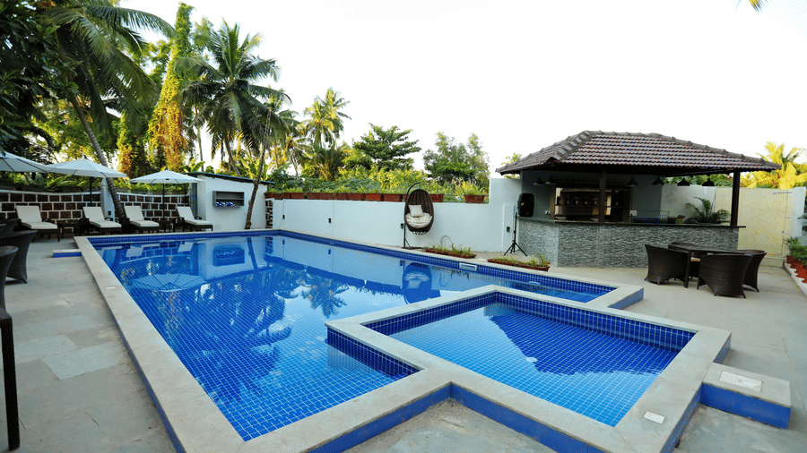Side view of the swimming pool at Amara Grand Baga, Goa, with a shack beside it.
