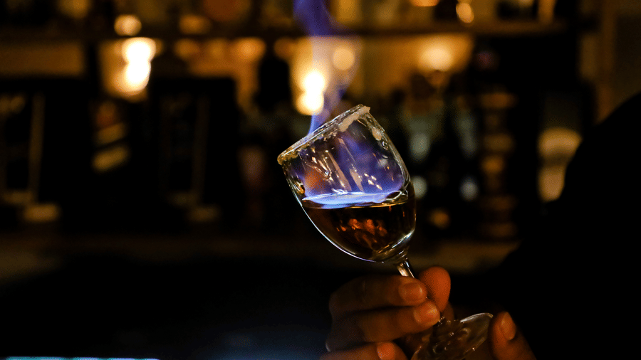 A wine glass with a flame rising from within at Amara Grand Baga, Goa.