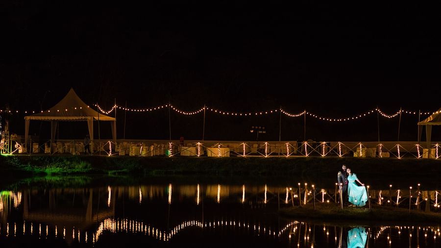 A decorated building next to a lake at The Lakeside, Capitol Village Resort, Madikeri