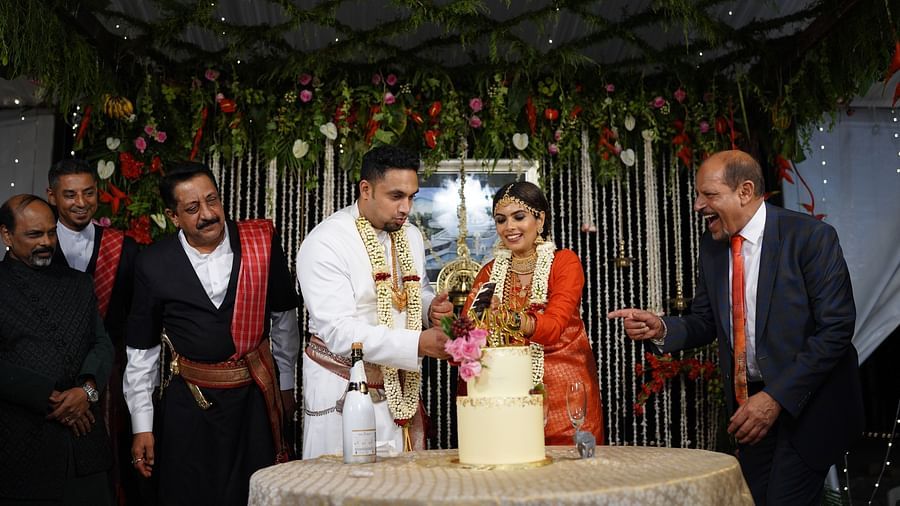 A kodava couple cutting a cake at Aiyanna Lawns, Capitol Village Resort, Madikeri