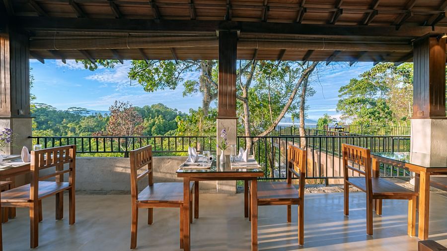 Chairs and tables in an al fresco restaurant with a mountain view | Celestial Hills, Kandy
