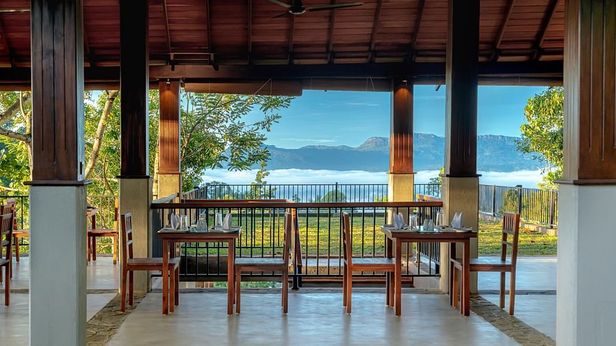 Chairs and tables placed in an al fresco dining set up with a mountain view | Celestial Hills, Kandy