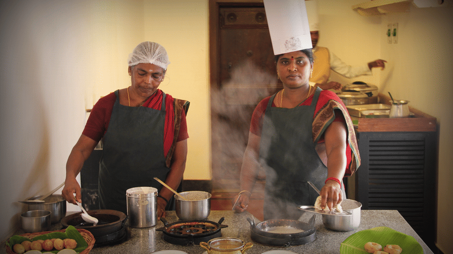 Two cooks conducting a cooking workshop at Chidambara Vilas while making Chettinad Indian Cuisine.