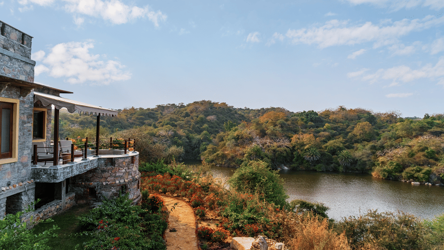 Side facade view of Chunda Shikar Oudi with the forest and lake surrounding it - Chunda Shikar Oudi.
