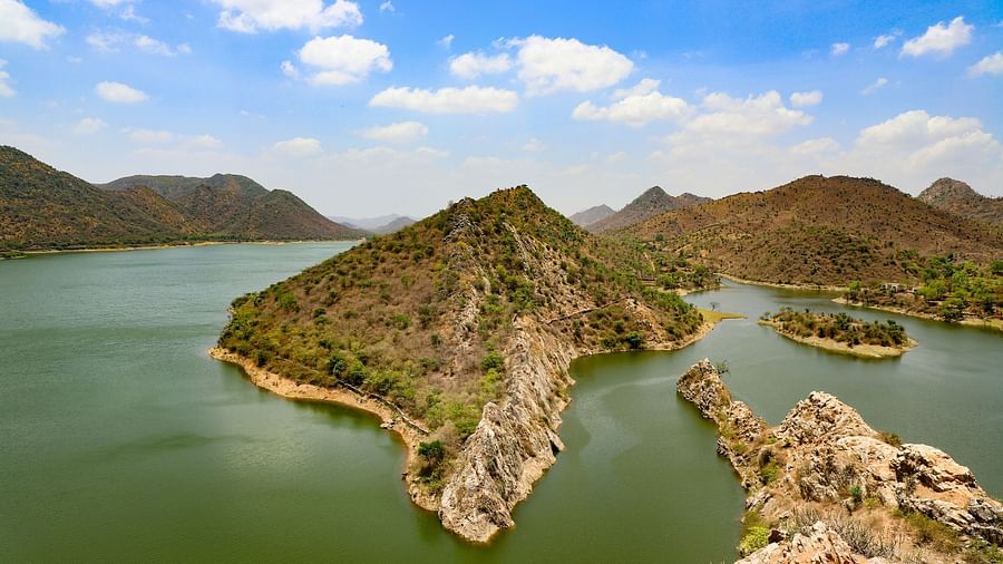 many small islands in one of the lakes in Udiapur with blue sky in the background