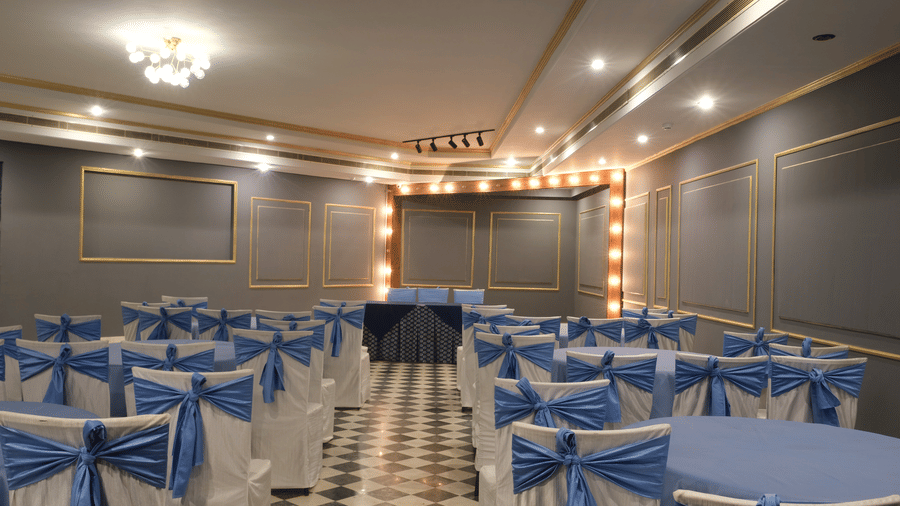 The beautifully appointed Party Hall with decorative lighting, elegant chair décor, and a cosy setting ideal for engagement ceremonies, cocktail evenings, and private celebrations | Clarks Amer, Jaipur