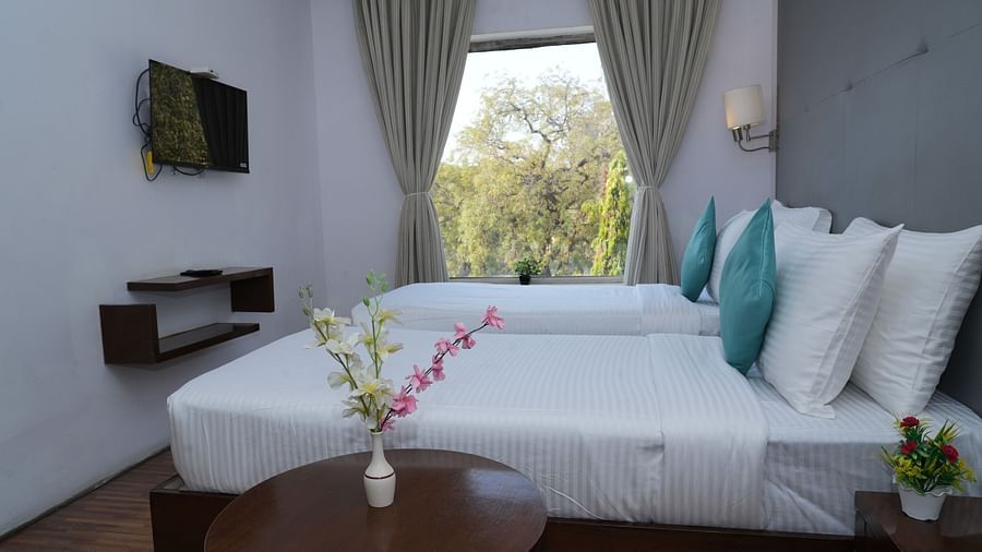 Executive room with a bed and a wall-mounted TV at Clarks Collection, Bhavnagar