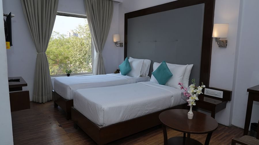 Executive room featuring a bed with two lights on each side at Clarks Collection, Bhavnagar