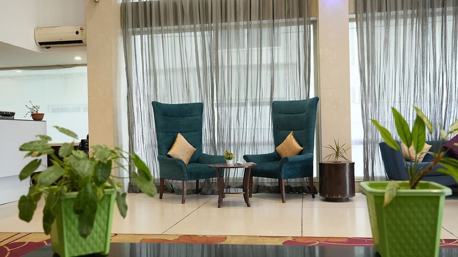 Lobby area furnished with two chairs and a coffee table at Clarks Collection, Bhavnagar