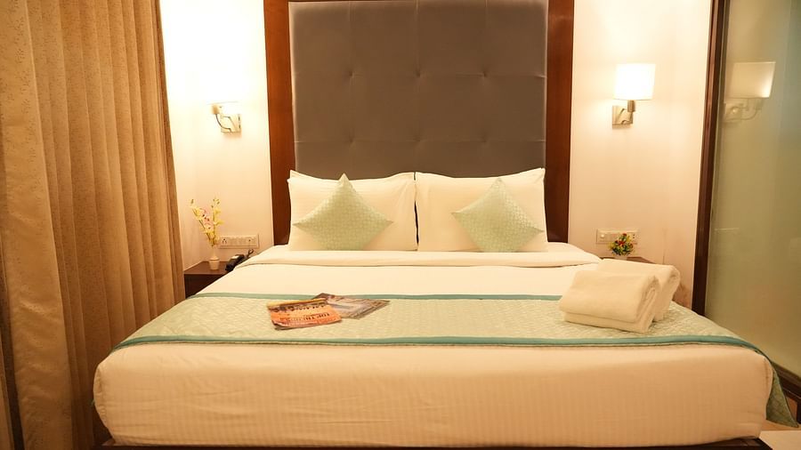 Premium room with a comfortable bed and bedside lights on each side at Clarks Collection, Bhavnagar