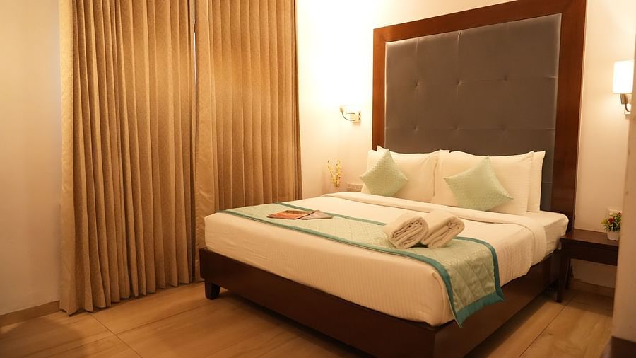 Premium room with a comfortable bed and bedside lights on each side at Clarks Collection, Bhavnagar