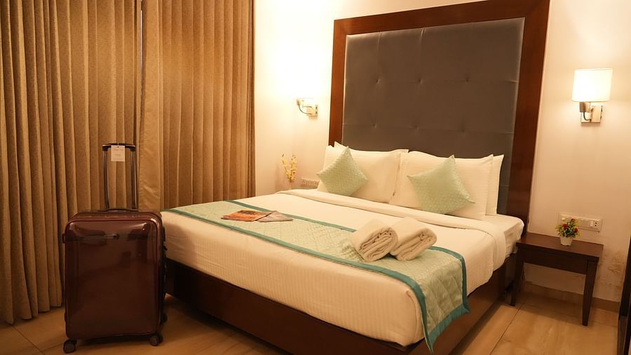 Premium room with a comfortable bed and bedside lights on each side at Clarks Collection, Bhavnagar