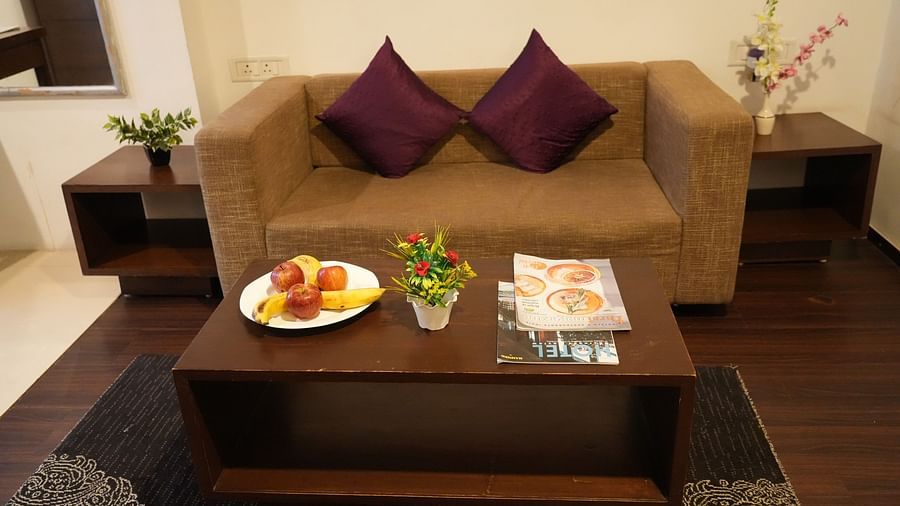 Inside the suite room, featuring a two-seater sofa at Clarks Collection, Bhavnagar