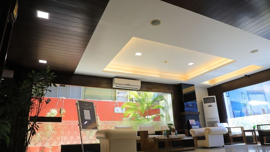 Lobby side view, decorated ceiling with brown borders and warm white lighting in the center