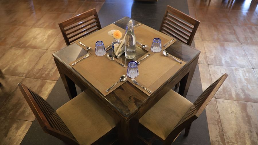 Dining Table with Four Wooden Chairs and a Square Table with decorative plate mat