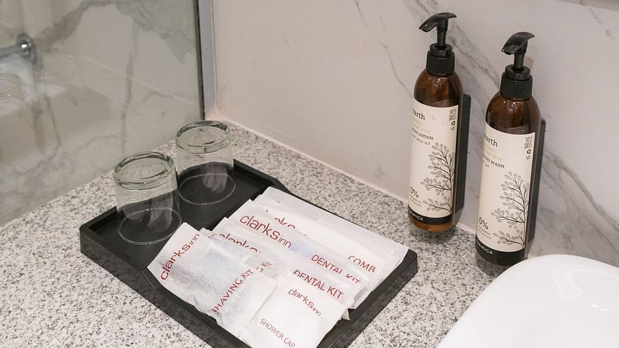 Hotel amenities tray with toiletries and towels.