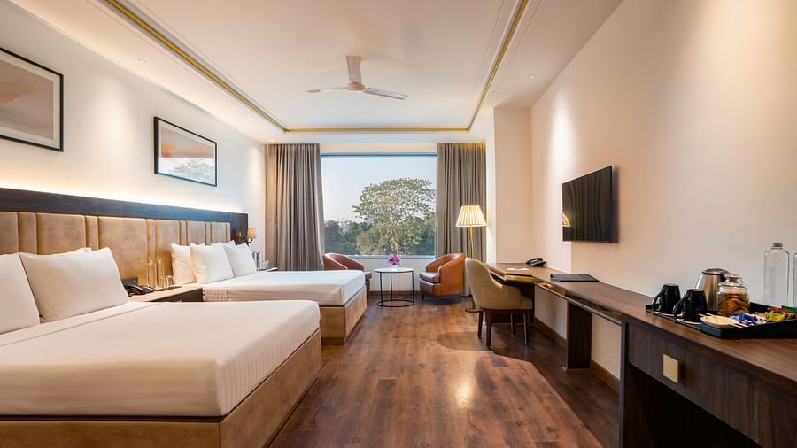 Comfortable guest room with a spacious bed and large window - Clarks Inn, Dehradun