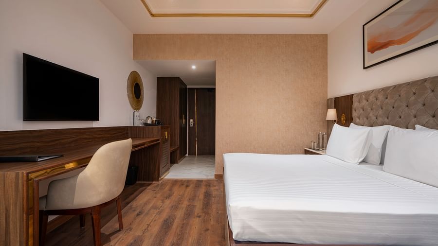 Modern hotel room with a minimalist design and natural light - Clarks Inn, Dehradun