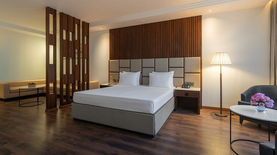 Modern hotel room with a minimalist design and natural light - Clarks Inn, Dehradun