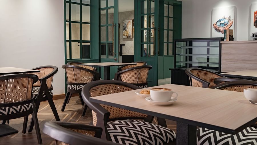 Cozy cafe seating area with comfortable chairs and tables.