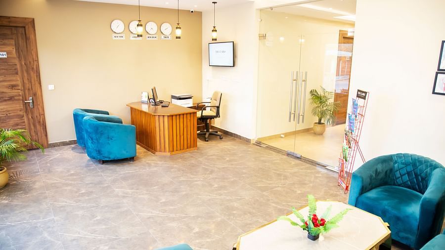 Reception area at Clarks Inn hotel with blue seats