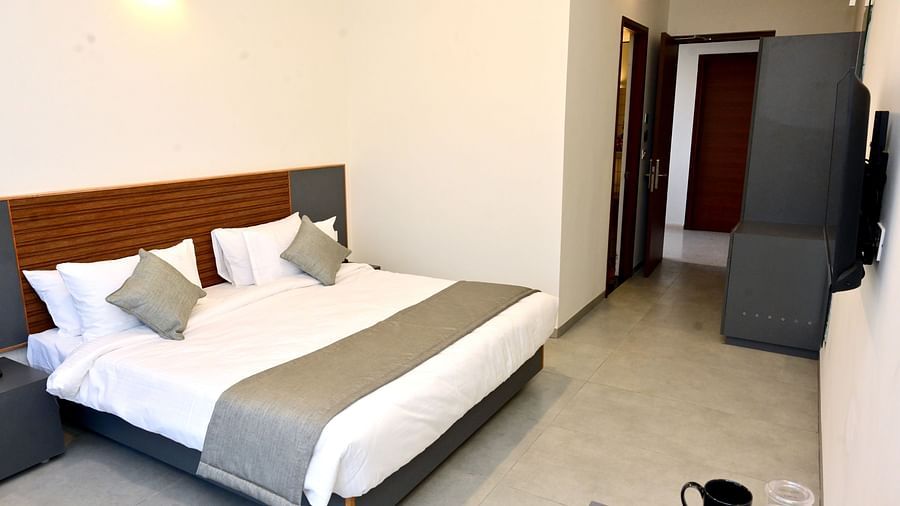 Well lit Standard Room with a double bed, wardrobe and television - Clarks Inn Express, KRS Road, Mysore