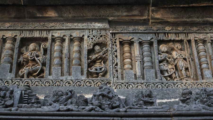 carvings of idols on a stone wall