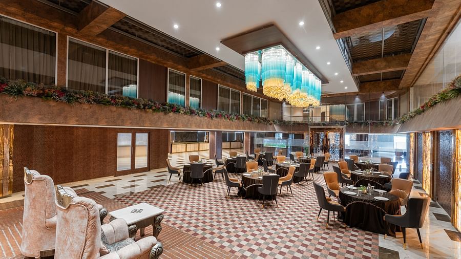 Chic lounge area with patterned flooring, plush seating and ambient lighting at Clarks Inn Suites, Hyderabad